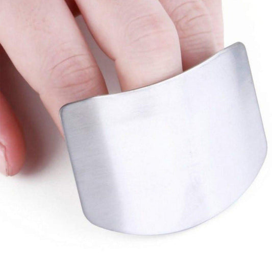 Stainless steel finger guard for safe cutting in kitchen.