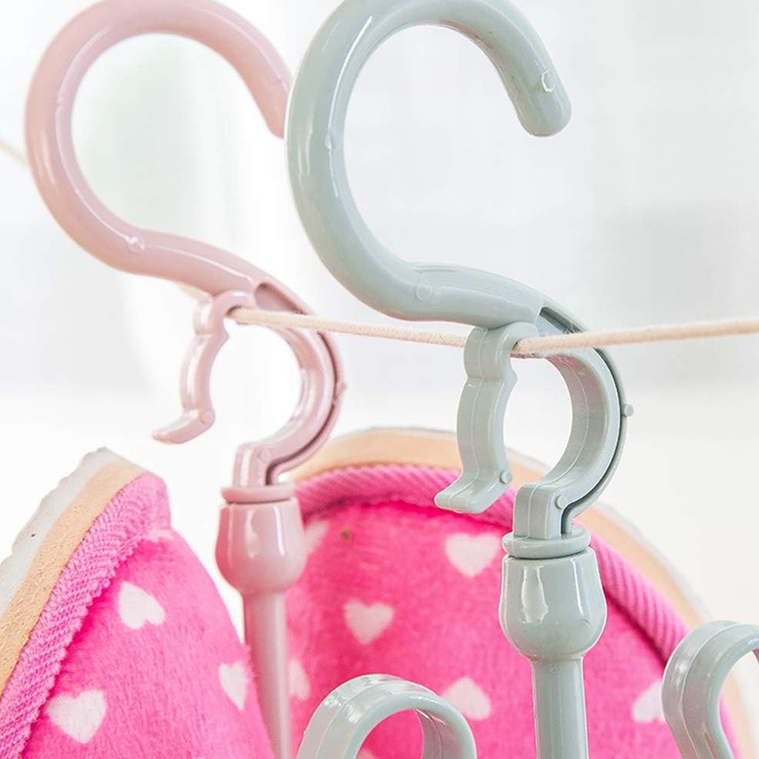 Adjustable and rotatable shoe hanger for effective drying in closet or balcony.