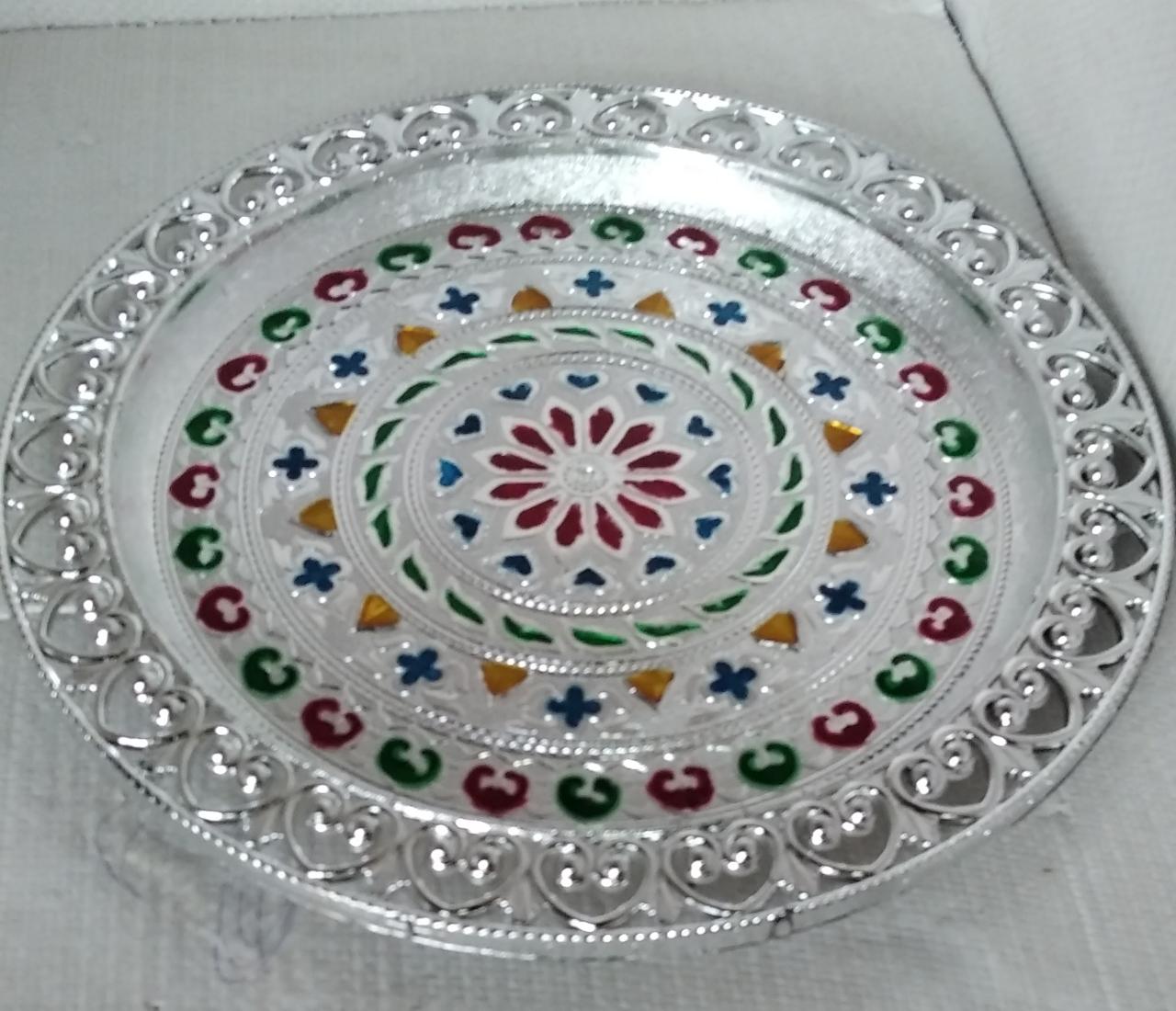 Silver plated pooja thali for religious ceremonies.